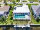 Overhead view showcasing the enclosed pool area, surrounding palm trees, and waterfront access at 2180 Via Esplanade, Punta Gorda, FL 33950