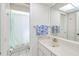 Well-lit bathroom with a large mirror and a shower area with a white shower curtain at 2180 Via Esplanade, Punta Gorda, FL 33950