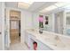 Large bathroom with double sink vanity and mirrored sliding doors leading to a walk-in closet at 2180 Via Esplanade, Punta Gorda, FL 33950