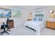 Bright bedroom with two windows, tile flooring, ceiling fan, and white bedding at 2180 Via Esplanade, Punta Gorda, FL 33950
