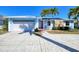 Charming blue single-story home with well-maintained landscaping, stone accents, and a spacious driveway and garage at 2180 Via Esplanade, Punta Gorda, FL 33950