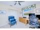 Comfortable home office space with a modern ceiling fan, bright window, and blue leather chair at 2180 Via Esplanade, Punta Gorda, FL 33950