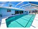 Relaxing pool area with an enclosed screen, outdoor seating, and a clean, refreshing pool at 2180 Via Esplanade, Punta Gorda, FL 33950