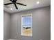 Bedroom with ceiling fan and a bright window at 24473 San Rafael Rd, Punta Gorda, FL 33955