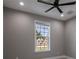 Bright bedroom with ceiling fan and view at 24473 San Rafael Rd, Punta Gorda, FL 33955