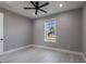 Bright bedroom with a ceiling fan, window, and neutral decor at 24473 San Rafael Rd, Punta Gorda, FL 33955