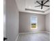 A peaceful bedroom with a ceiling fan and a window view at 24473 San Rafael Rd, Punta Gorda, FL 33955