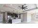 Open concept kitchen boasts stainless appliances, breakfast bar, and modern pendant lights at 24473 San Rafael Rd, Punta Gorda, FL 33955