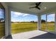 Screened-in lanai boasts ample space and panoramic views of the surrounding green space and blue skies at 24473 San Rafael Rd, Punta Gorda, FL 33955