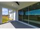 Relaxing screened-in lanai features ceiling fan and sliding glass doors to the interior of the home at 24473 San Rafael Rd, Punta Gorda, FL 33955