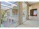 Balcony featuring tile flooring, a white railing, and sliding glass doors for indoor-outdoor living at 250 George Rd, Port Charlotte, FL 33952