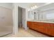 Well-lit bathroom features a dual sink vanity with granite counters and a glass enclosed shower at 250 George Rd, Port Charlotte, FL 33952