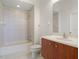 Bathroom featuring tile flooring, shower and tub, light wood cabinet and large mirror at 250 George Rd, Port Charlotte, FL 33952