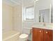 Bathroom featuring a vanity with cabinet, a bathtub with shower, and a window for natural light at 250 George Rd, Port Charlotte, FL 33952