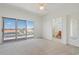 Bright bedroom with ceiling fan, sliding glass doors to the balcony and an en-suite bathroom at 250 George Rd, Port Charlotte, FL 33952