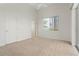 Bright bedroom featuring neutral carpet, a ceiling fan and a large window for natural light at 250 George Rd, Port Charlotte, FL 33952