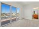 Light-filled bedroom with sliding glass doors to balcony, and an en-suite bathroom at 250 George Rd, Port Charlotte, FL 33952