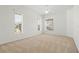 Bright bedroom featuring neutral carpet, a ceiling fan and three large windows for natural light at 250 George Rd, Port Charlotte, FL 33952