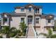 Elegant two-story home featuring stone accents, a metal roof, a two-car garage, and manicured landscaping at 250 George Rd, Port Charlotte, FL 33952