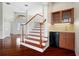 Inviting foyer boasts hardwood floors, staircase, and wet bar area, offering an elegant welcome to this stylish home at 250 George Rd, Port Charlotte, FL 33952