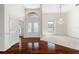 Bright foyer featuring beautiful hardwood floors, arched windows, and an elegant chandelier, inviting entrance at 250 George Rd, Port Charlotte, FL 33952