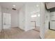 Upstairs hallway with neutral carpet leads to bedrooms and has access to the laundry room at 250 George Rd, Port Charlotte, FL 33952