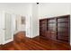 Open-concept office showcases built-in shelving, hardwood floors, and french doors that lead to other rooms at 250 George Rd, Port Charlotte, FL 33952