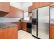 Well-appointed kitchen features stainless steel appliances, granite countertops, and warm wood cabinetry at 250 George Rd, Port Charlotte, FL 33952