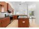 Stylish kitchen offers a center island, stainless appliances, and tile flooring, creating a functional and chic design at 250 George Rd, Port Charlotte, FL 33952