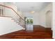 Spacious living room with hardwood floors, staircase, large windows, and access to the outdoor lanai, creating a bright space at 250 George Rd, Port Charlotte, FL 33952