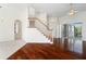 Elegant living room with hardwood floors, staircase, arched windows and doorways, creating a bright, open space at 250 George Rd, Port Charlotte, FL 33952