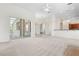 Spacious living room with sliding glass doors to the lanai and adjacent kitchen area at 250 George Rd, Port Charlotte, FL 33952