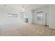 Bright main bedroom features plush carpeting, a ceiling fan, and sliding glass doors to the lanai at 250 George Rd, Port Charlotte, FL 33952
