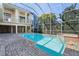 Stunning screened-in pool area with covered lanai and lush landscaping at 250 George Rd, Port Charlotte, FL 33952