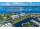 Aerial view showcasing waterfront condos with lush landscaping and stunning water views at 25188 Marion Ave # F303, Punta Gorda, FL 33950