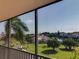 Scenic view from the balcony overlooking greenery and a waterfront at 25188 Marion Ave # F303, Punta Gorda, FL 33950