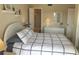 Inviting bedroom with a comfy bed, dresser, and a view into the ensuite bathroom at 25188 Marion Ave # F303, Punta Gorda, FL 33950