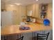 Efficient kitchen with a breakfast bar and functional appliances at 25188 Marion Ave # F303, Punta Gorda, FL 33950