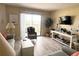Cozy living room with a balcony, sliding glass doors, comfortable chair, and stylish console table at 25188 Marion Ave # F303, Punta Gorda, FL 33950