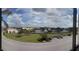 Scenic view of waterway, lush landscaping, and surrounding buildings, seen from the balcony at 25188 Marion Ave # F303, Punta Gorda, FL 33950