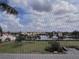 Scenic view of waterway, lush landscaping, and surrounding buildings, seen from the balcony at 25188 Marion Ave # F303, Punta Gorda, FL 33950