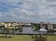 Scenic view of waterway, lush landscaping, and surrounding buildings, seen from the balcony at 25188 Marion Ave # F303, Punta Gorda, FL 33950