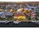 Aerial view of the backyard, featuring a screened-in pool, boat dock, and waterfront access at 257 Lido Dr, Punta Gorda, FL 33950