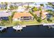 Aerial view of the backyard, featuring a screened-in pool, boat dock, and waterfront access at 257 Lido Dr, Punta Gorda, FL 33950