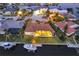 Stunning aerial view of a waterfront property with a private dock and lush landscaping at twilight at 257 Lido Dr, Punta Gorda, FL 33950