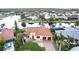 Aerial shot featuring home's red-tiled roof in a serene waterfront setting with canal access at 257 Lido Dr, Punta Gorda, FL 33950