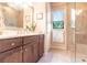 Bathroom features dark wood cabinets and a beautifully tiled walk-in shower at 257 Lido Dr, Punta Gorda, FL 33950