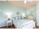 Bright bedroom features a white wood frame bed with light blue and green patterned bedspread at 257 Lido Dr, Punta Gorda, FL 33950