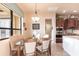 Eat-in kitchen/dining area featuring tile flooring, a glass table with wood chairs, and stainless steel appliances at 257 Lido Dr, Punta Gorda, FL 33950