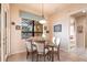 Bright dining room features a glass-top table with seating for four and serene backyard views at 257 Lido Dr, Punta Gorda, FL 33950